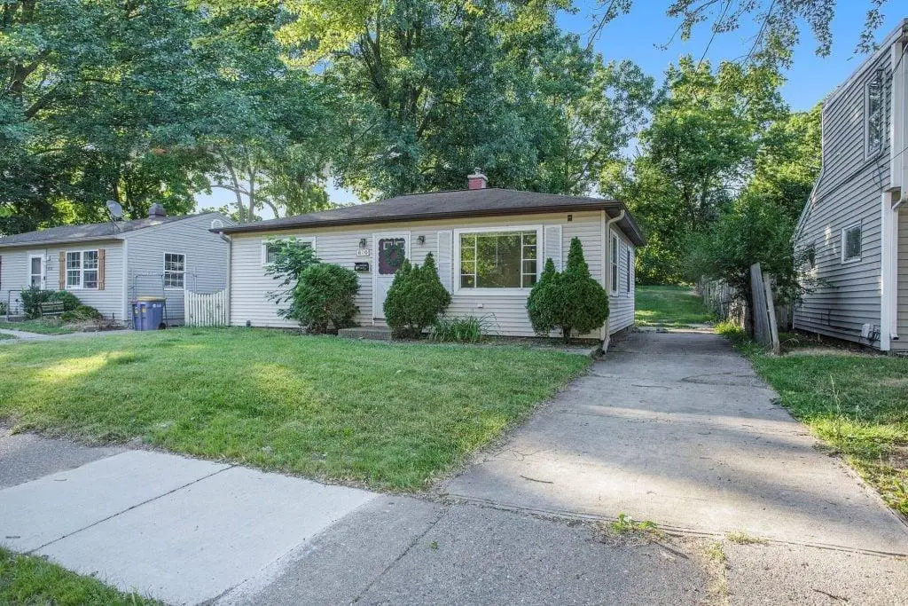 Small suburban house with green front yard.